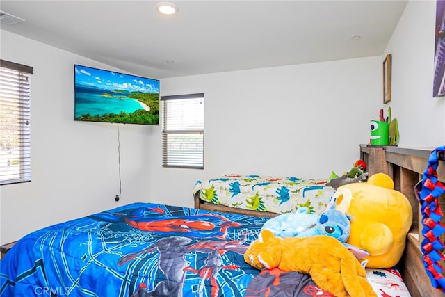 bedroom with multiple windows