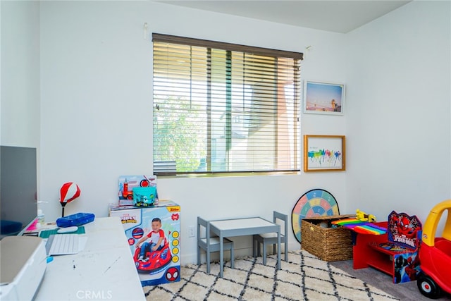 recreation room with light carpet