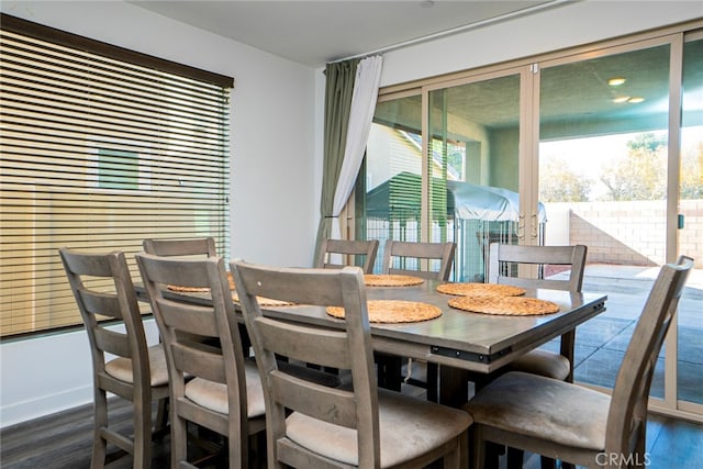 dining area with dark hardwood / wood-style flooring