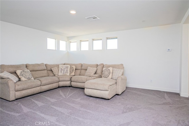 carpeted living room with a healthy amount of sunlight