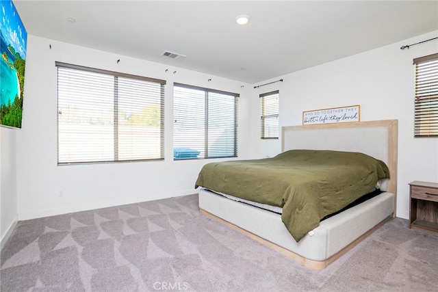 bedroom with light colored carpet