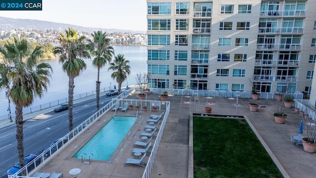 view of pool featuring a mountain view and a patio