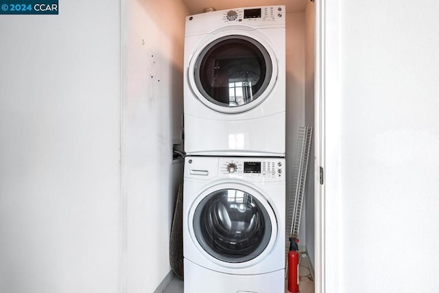 washroom featuring stacked washing maching and dryer