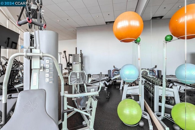 exercise room featuring a drop ceiling