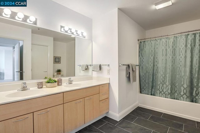 bathroom featuring vanity and shower / bathtub combination with curtain