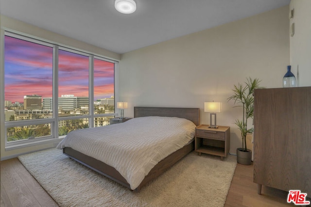 bedroom with hardwood / wood-style flooring