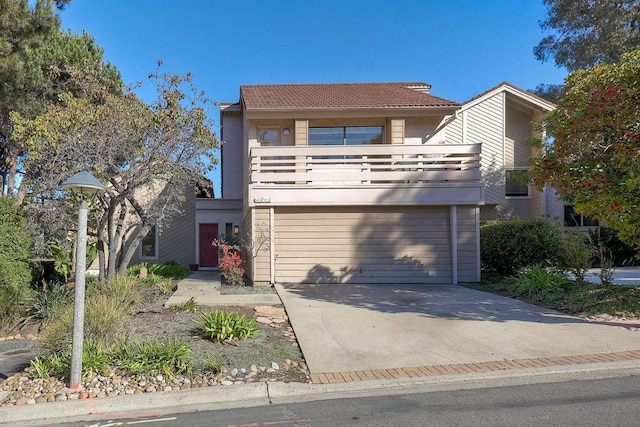 view of front of property featuring a garage and a balcony