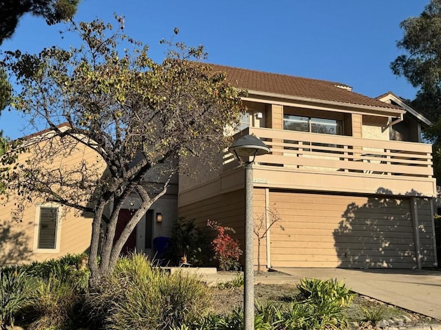 exterior space featuring a garage and a balcony