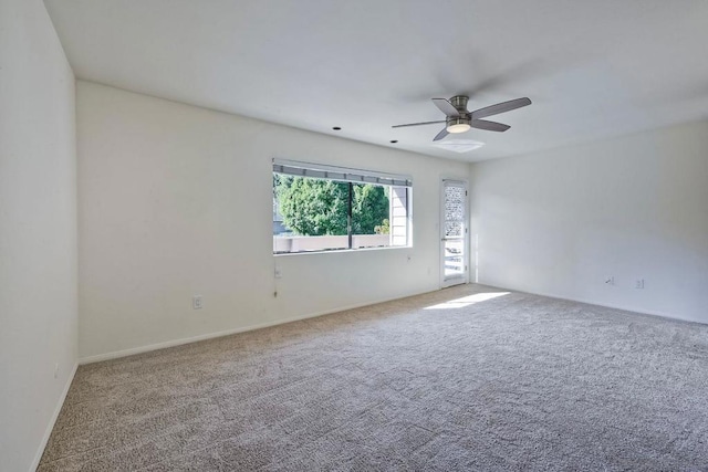 carpeted spare room with ceiling fan