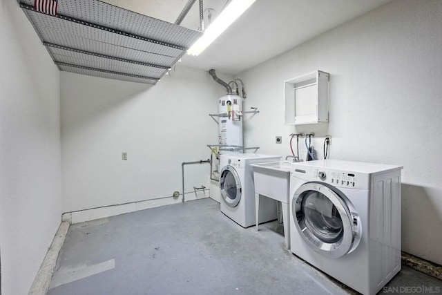 clothes washing area with washer and clothes dryer and gas water heater