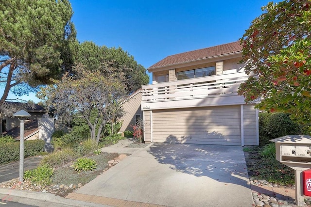 view of front of home featuring a balcony and a garage