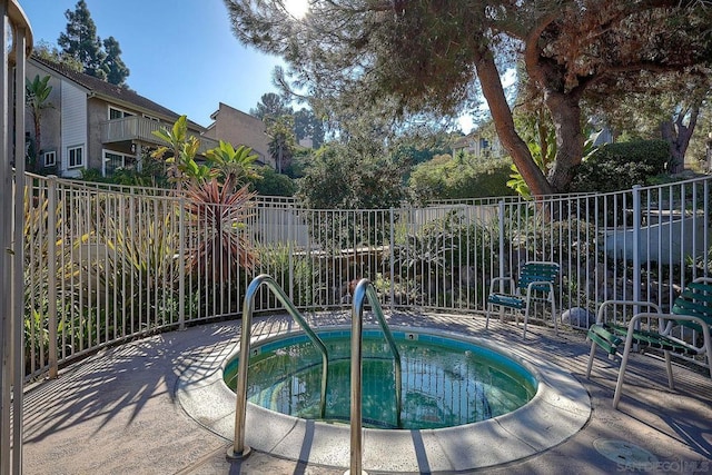 view of pool featuring a community hot tub and a patio