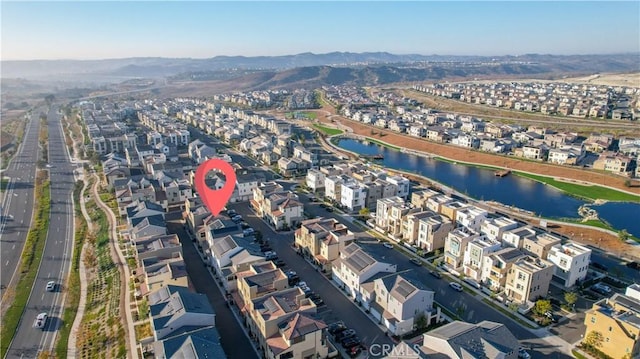 drone / aerial view featuring a water and mountain view