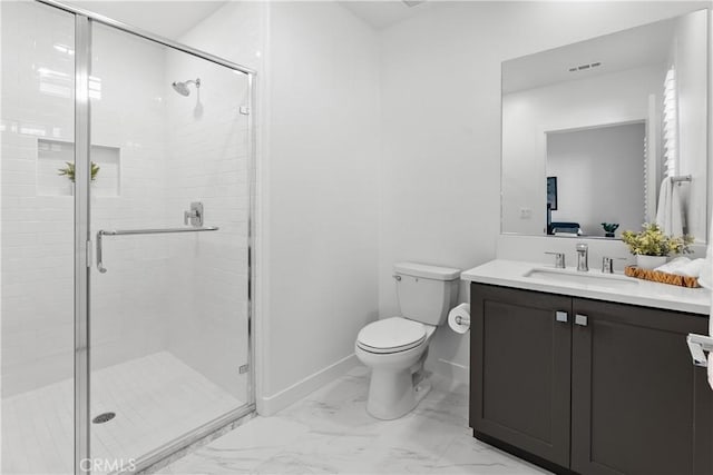 bathroom featuring vanity, toilet, and a shower with door