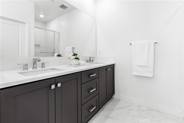 bathroom with vanity and a shower with shower door