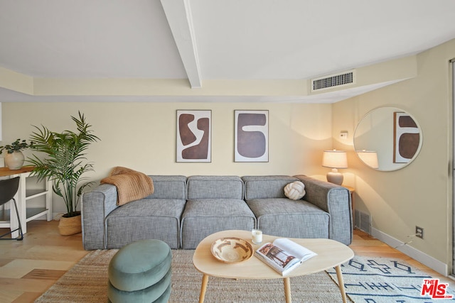 living room with beamed ceiling and light hardwood / wood-style floors