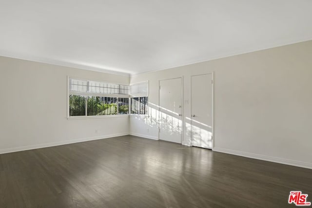 empty room featuring dark wood-type flooring