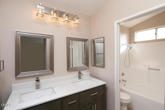 full bathroom featuring bathing tub / shower combination, a textured ceiling, lofted ceiling, toilet, and vanity