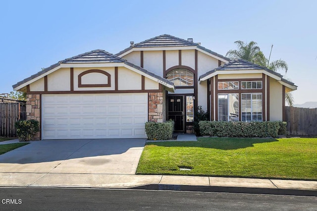 tudor home featuring a front lawn and a garage