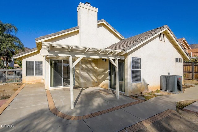 back of house with a pergola, a patio area, and central air condition unit