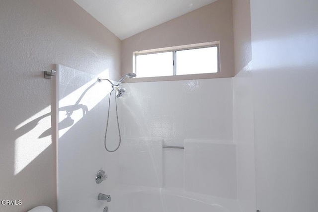 bathroom with  shower combination, toilet, and lofted ceiling