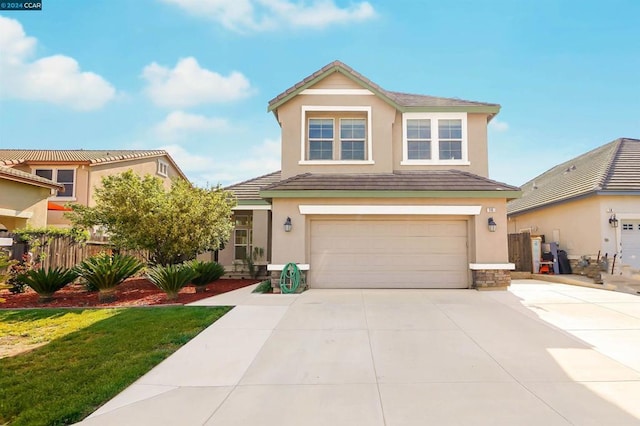 front of property featuring a front yard and a garage