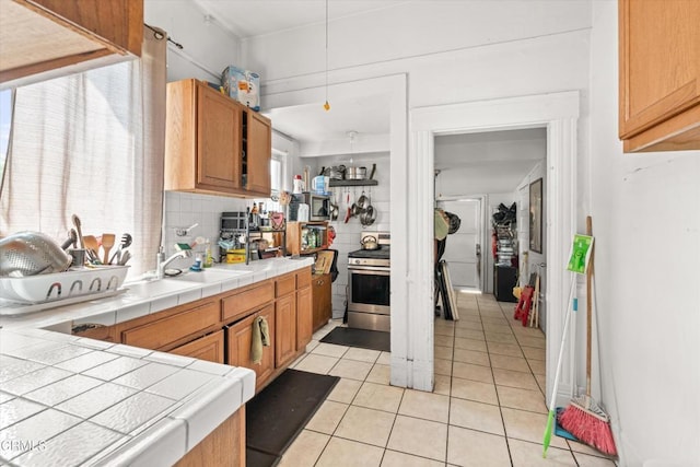 kitchen featuring decorative backsplash, tile counters, and a healthy amount of sunlight