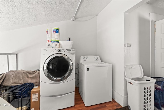 laundry area with separate washer and dryer, a textured ceiling, and hardwood / wood-style flooring