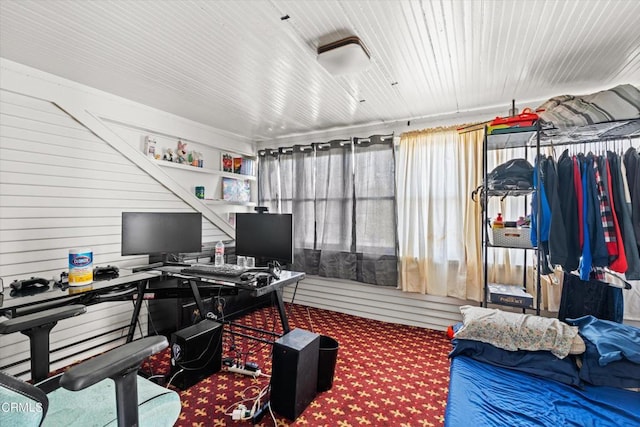 home office with carpet and wooden walls