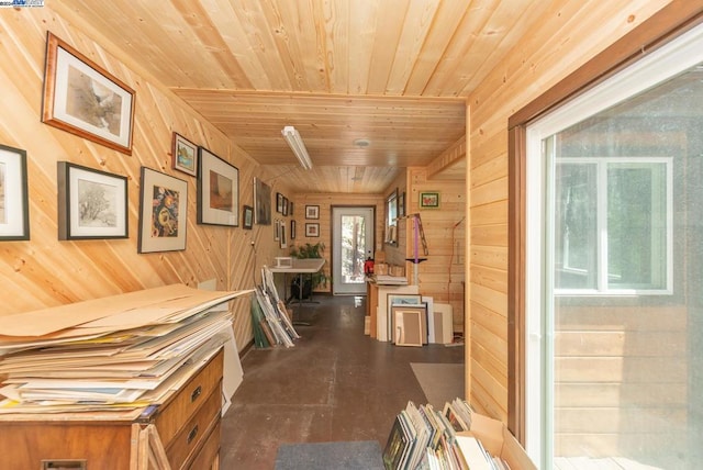 hallway with wooden ceiling and wooden walls