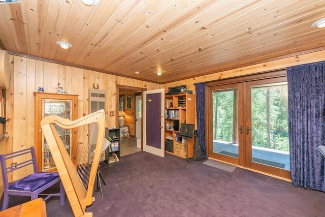 workout room featuring wood walls, dark carpet, wood ceiling, and french doors