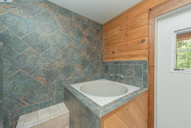 bathroom with a relaxing tiled tub