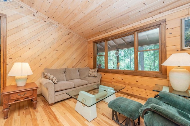 living room with wood ceiling, light wood-type flooring, and wooden walls