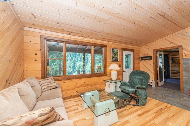 living room with hardwood / wood-style flooring, wooden ceiling, and wooden walls