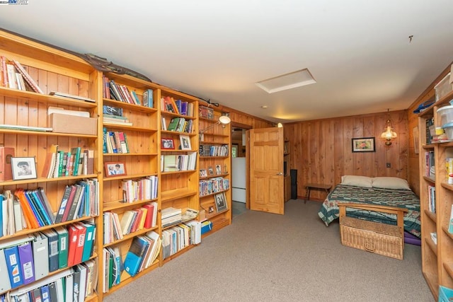 carpeted bedroom featuring wooden walls