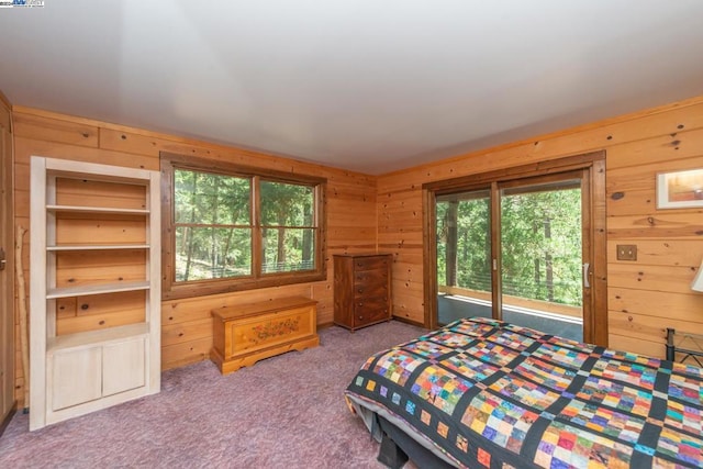 carpeted bedroom with wood walls