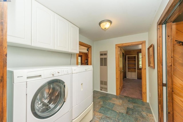 washroom with washer and clothes dryer and cabinets