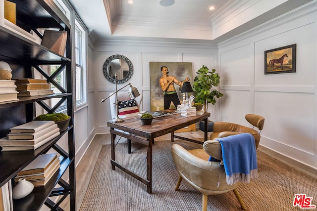 office area with a raised ceiling, crown molding, and hardwood / wood-style floors