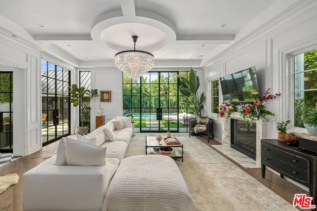 sunroom / solarium with a notable chandelier and coffered ceiling