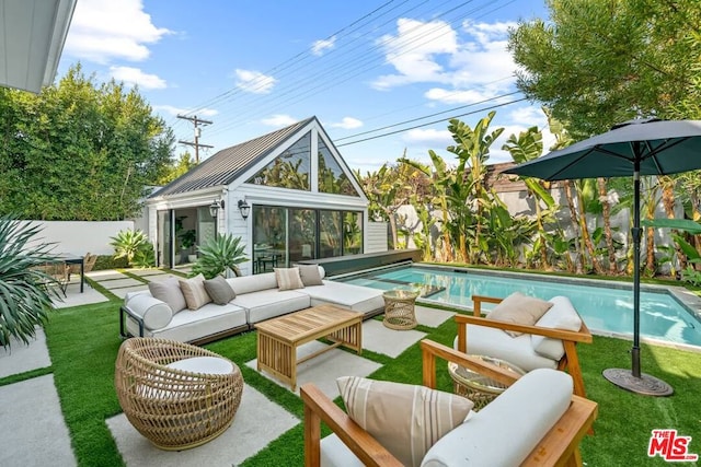 view of pool featuring an outdoor structure, outdoor lounge area, a lawn, and a patio