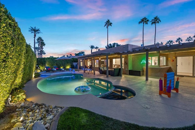 pool at dusk featuring a jacuzzi and a patio