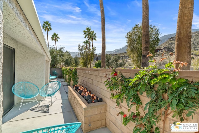 view of patio / terrace featuring a mountain view