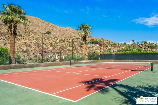 view of sport court featuring a mountain view and basketball court