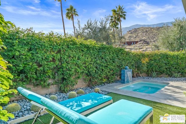 view of pool featuring a mountain view and a patio