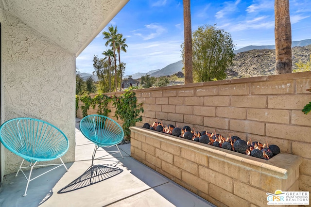 view of patio / terrace with a mountain view