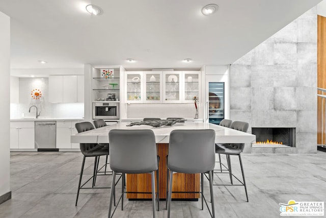 dining space with a tile fireplace and sink