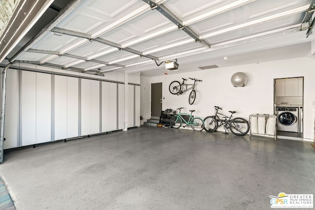 garage with washer / dryer and a garage door opener