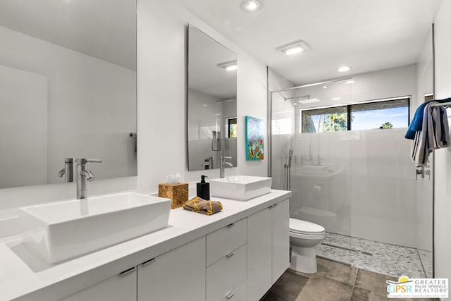 bathroom with vanity, a shower with shower door, and toilet