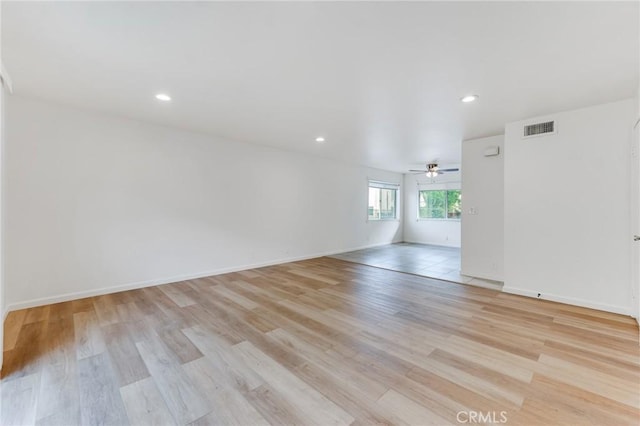 unfurnished room with ceiling fan and light wood-type flooring