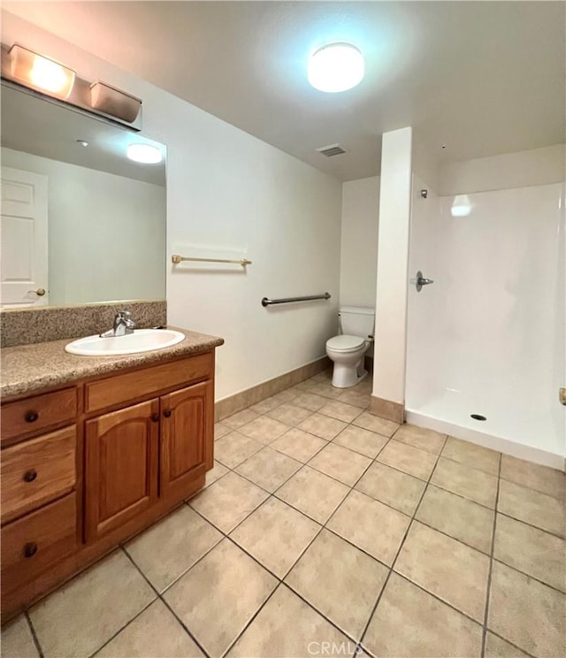 bathroom featuring walk in shower, tile patterned flooring, vanity, and toilet